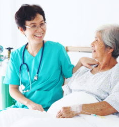 nurse and senior woman talking