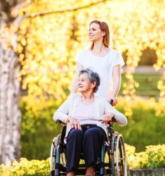 caregiver and senior woman in a wheelchair