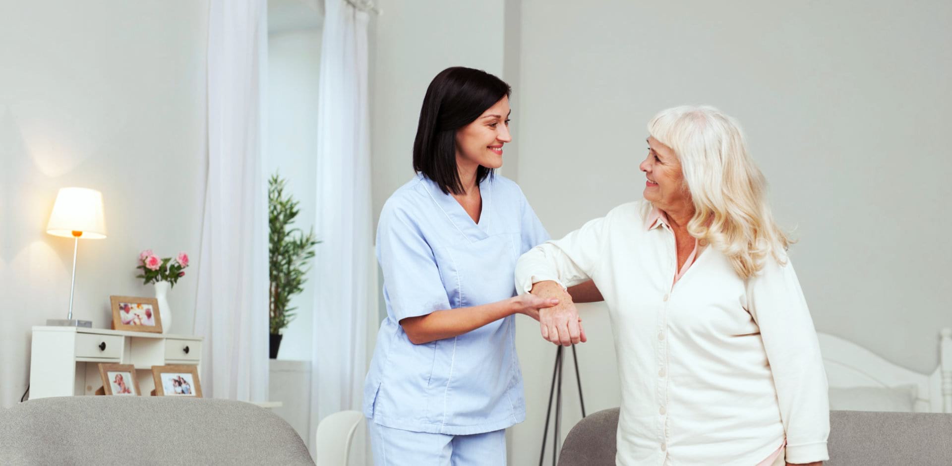 portrait of caregiver helping senior woman