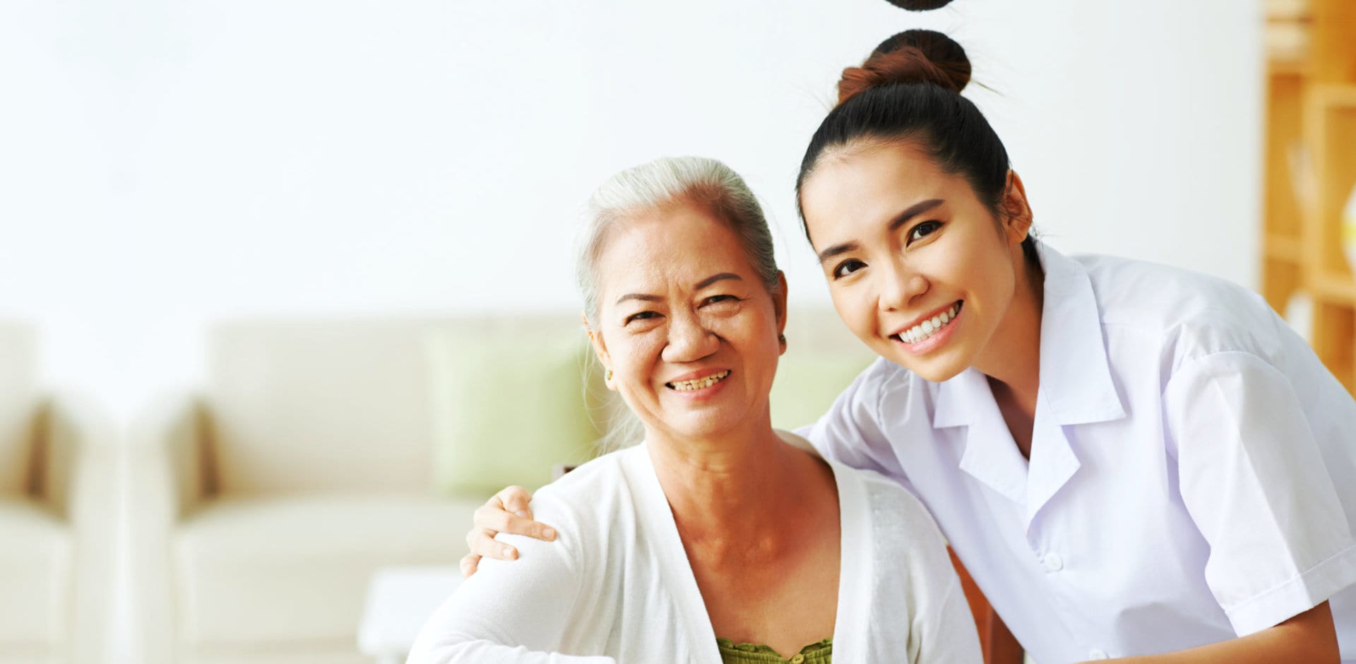 portrait of caregiver and senior woman smiling