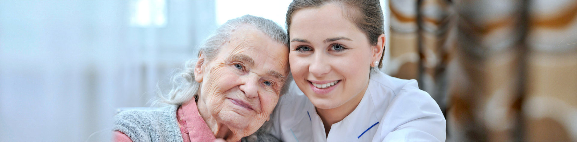caregiver and senior woman smiling